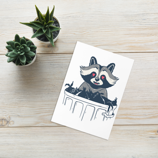 Flat lay of raccoon greeting card with envelope and small plant props