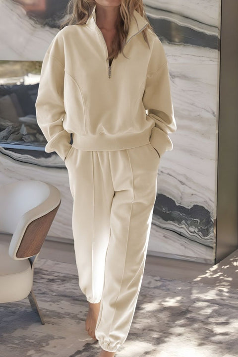 Woman wearing cream half-zip pullover and jogger loungewear set