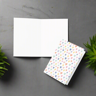 Inside view of pastel hearts greeting card showing blank interior for personal message