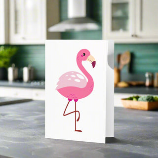 Pink Flamingo Greeting Card standing on a kitchen counter – blank inside with tropical bird design and envelope