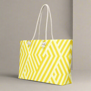 Side angle of yellow geometric oversized weekender tote with cream rope straps
