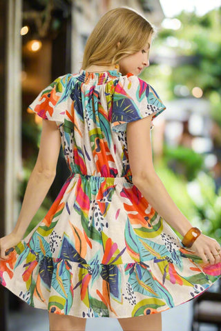 Back view of women’s colorful drawstring waist mini dress, lightweight and flowy for warm days