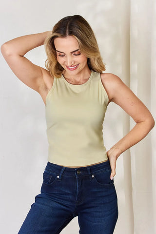 Woman wearing beige ribbed sleeveless cropped tank top