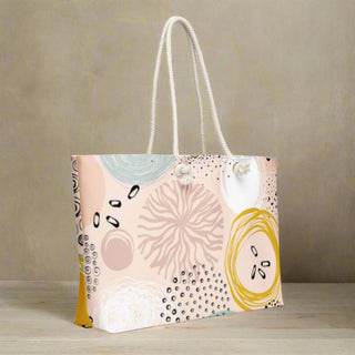 Oversized rope-handle weekender tote styled in indoor setting