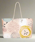 Side angle of large abstract travel tote bag on flat surface