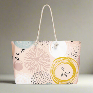 Side angle of large abstract travel tote bag on flat surface