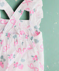 Pink berry & bow print baby romper with ruffle straps, flat lay back