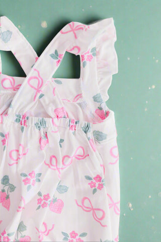 Pink berry & bow print baby romper with ruffle straps, flat lay back