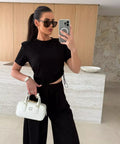 black two piece travel outfit set with crop top and wide leg pants