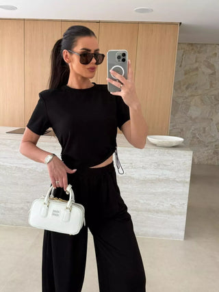 black two piece travel outfit set with crop top and wide leg pants