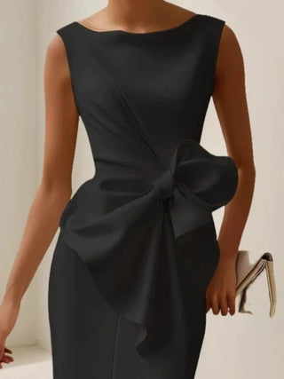 elegant black sleeveless cocktail dress featuring statement bow detail and tailored fit