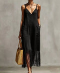 woman wearing black fringe hem maxi dress styled for resort vacation outfit