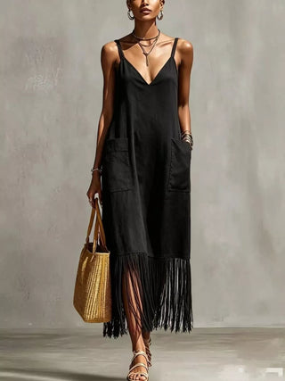 woman wearing black fringe hem maxi dress styled for resort vacation outfit