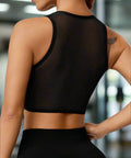 Back view of fitted seamless black cropped tank top
