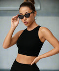 Woman styled in black seamless cropped tank and sunglasses