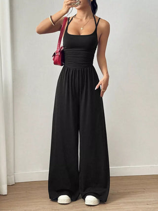 Women's black spaghetti strap wide leg jumpsuit styled for brunch, vacations, and casual summer outfits.