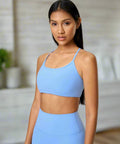 Woman in pastel blue cami and leggings set