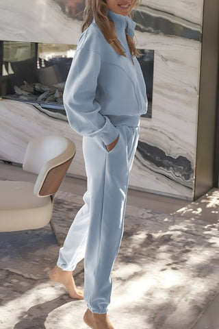 Side view of half-zip loungewear set in light blue with relaxed joggers