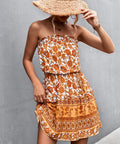 Side view of strapless orange print mini dress with elastic waist