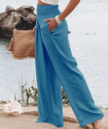woman wearing bright blue wide leg pants with elastic waist and pockets