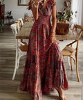 woman wearing burgundy boho smocked maxi dress with floral print and v neck silhouette