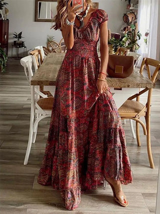 woman wearing burgundy boho smocked maxi dress with floral print and v neck silhouette