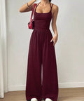 Women's burgundy spaghetti strap wide leg jumpsuit for date nights, winery weekends, and vacations.