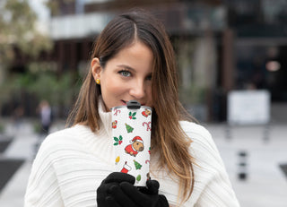 Woman holding Christmas capybara 20oz tumbler outdoors