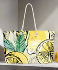 Back view of large yellow tote bag with bold citrus print and braided rope straps