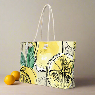 Oversized lemon-themed weekender tote bag styled with lemons on wood surface
