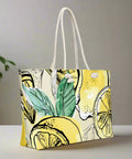 Side angle of lemon and green leaf print tote bag with soft cream rope handles