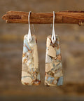 Earth-toned copper and natural stone dangle earrings with a unique handcrafted design.