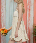 Side view of ruffle hem dress with smocked back and flared skirt