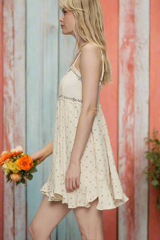 Side view of ruffle hem dress with smocked back and flared skirt