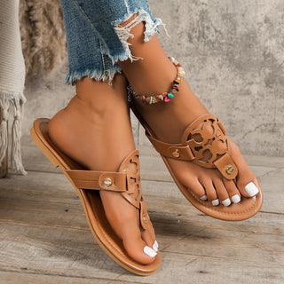 Brown flat sandals styled with jeans and anklet