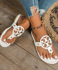 White version of cutout slip-on sandals styled with distressed denim