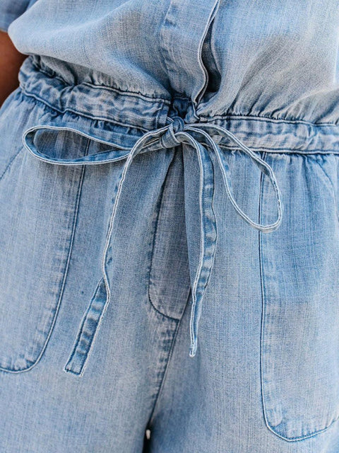 Close-up of drawstring waist and side pockets on denim romper