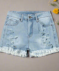 Flat lay of distressed jean shorts with raw hem and front rips 