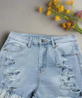 Angled view of ripped high waist denim shorts with light wash 