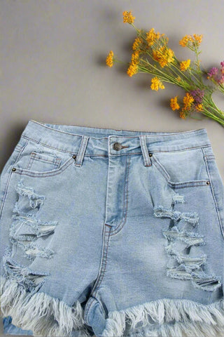 Angled view of ripped high waist denim shorts with light wash 