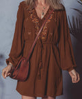 Woman wearing brown embroidered boho mini dress