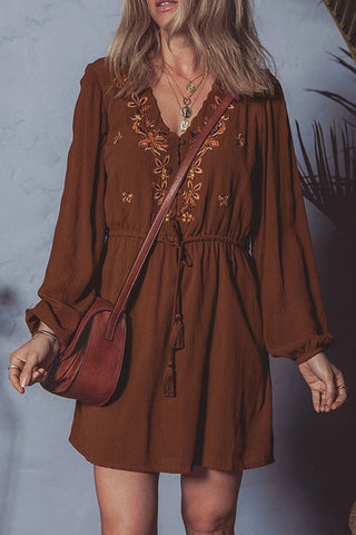 Woman wearing brown embroidered boho mini dress