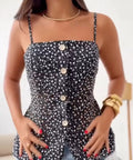 Close-up of a floral button front tank top with delicate floral print and decorative front buttons.