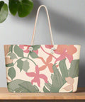 Front view of oversized floral tote bag with rope handles and pink-green abstract leaf print