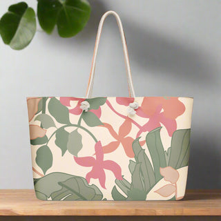 Front view of oversized floral tote bag with rope handles and pink-green abstract leaf print