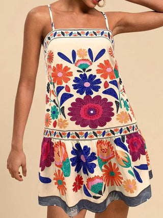 woman wearing colorful floral sleeveless mini dress for summer vacation outfit