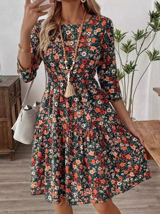 Flowy floral swing dress with ruched bodice and 3/4 sleeves