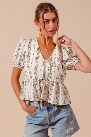 Angled view of floral print smocked hem blouse for spring