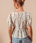 Back view of floral print smocked hem blouse for women