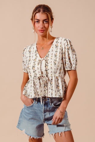 Close-up of floral pattern and smocked hem detail on women’s blouse